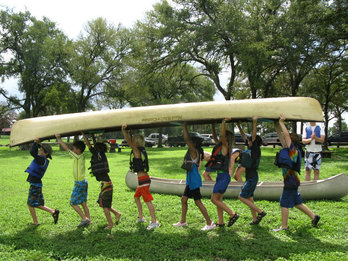 Children carrying a canoe.