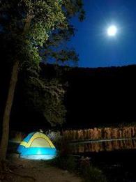 nighttime, full moon, tent lit from within