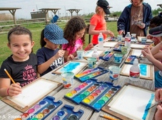 kids painting at picnic table