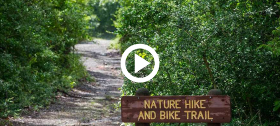 Nature Hike and Bike Trail sign in front of a state park trail