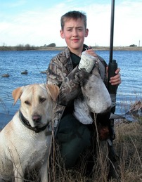 boy with ducks and yellow lab