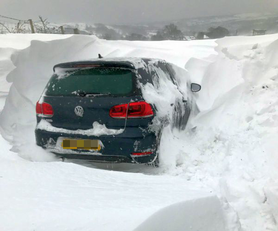 Car in snow drift near Silsden