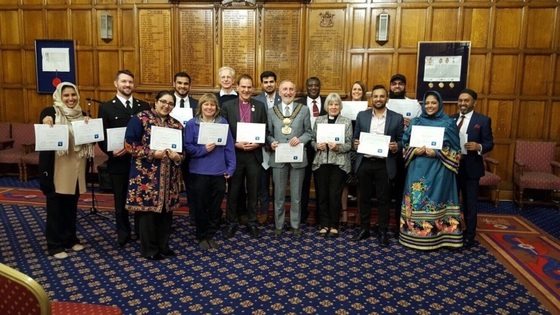 People from a variety of backgrounds in the banqueting hall of Bradford's City Hall