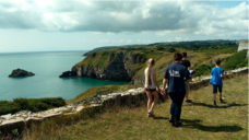 A picture of people walking along the coast path near Torbay