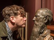 Bedwyr Williams staring at a bust of Veitch
