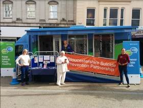 Members of the GSPP standing outside the CCG engagement bus on World Suicide Prevention Day 2018