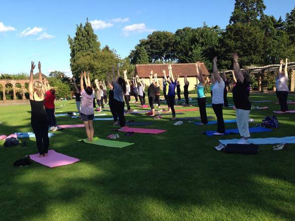 Women doing yoga in bushey rose garden