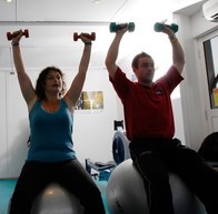 man and woman on exercise balls