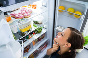 woman looking in a fridge