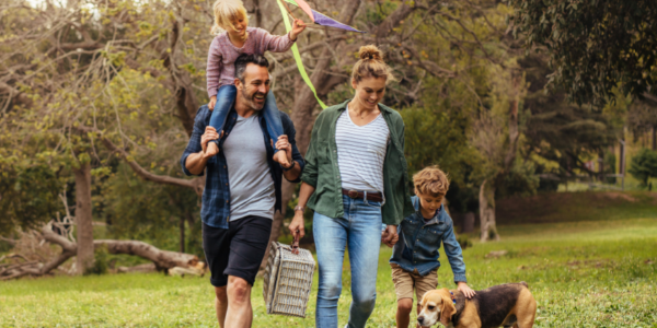 Family walking in the countryside with a picnic basket