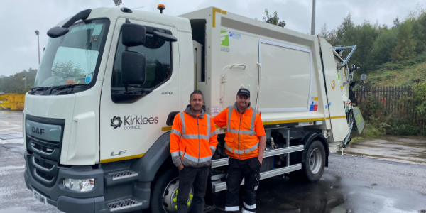Lee Kane and Graham Holdroyd standing by a new recycling wagon