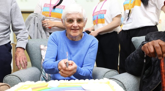 Resident cutting the cake at Ash View