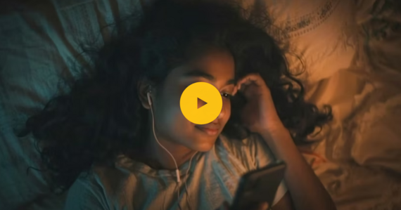 Still image from National Year of Reading video. Girl listening to audio book in bed