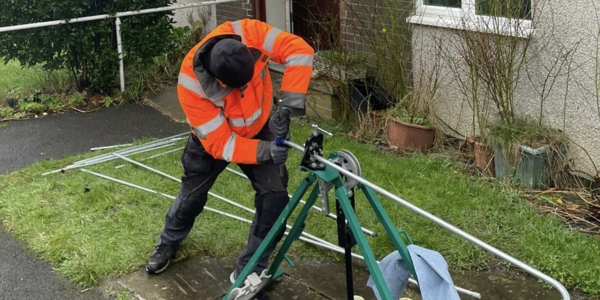 Worker bending steel tubing Kirklees Council