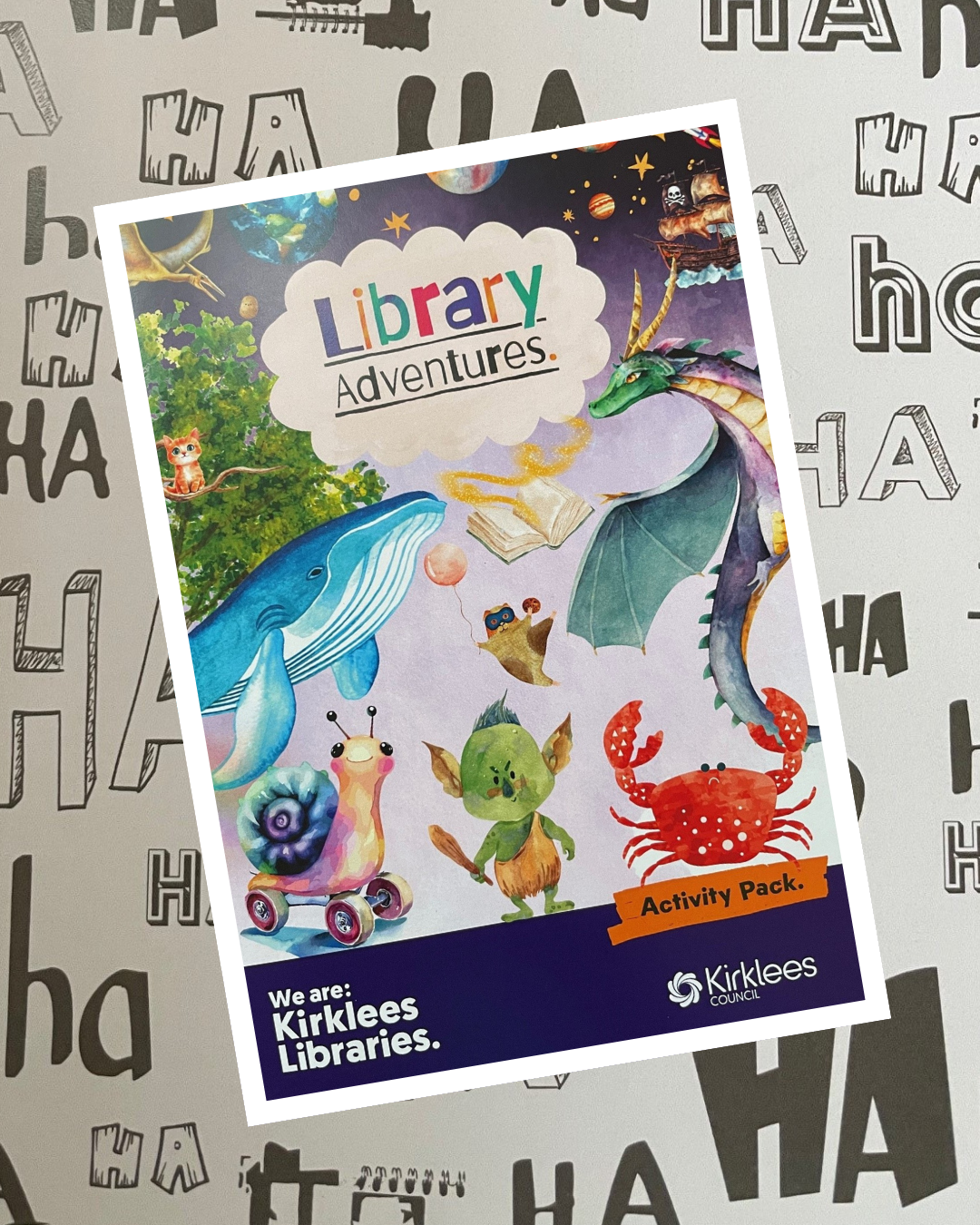 Image of new Library Adventures booklet with white border on laughter background - text reads ha, ha, ha