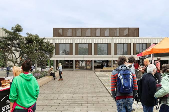 Image of new build Huddersfield Library with busy town square in front