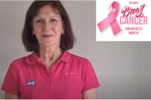 Head and shoulders shot of Julie looking at camera wearing a pink blouse and smiling