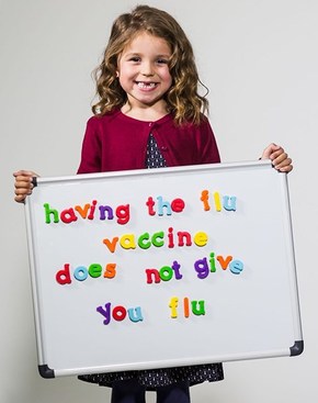 flu vaccine sign held by child