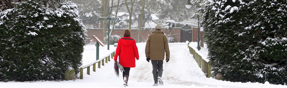 Couple walking in show at Rufford Country Park