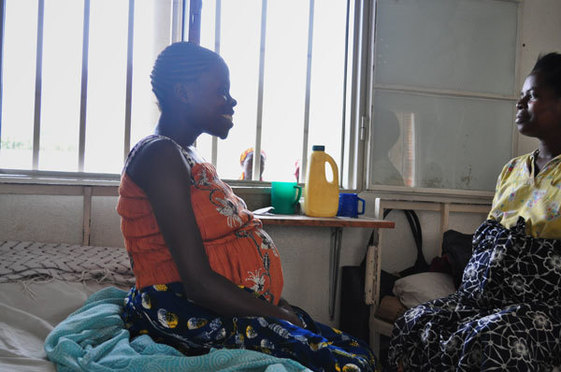 Two pregnant women talk together at a hospital