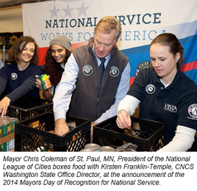 Mayor Chris Coleman of St. Paul, MN, President of the NLC, boxes food with Kirsten Franklin-Temple, CNCS Washington State Director.