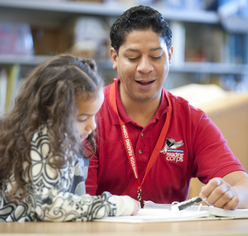 Minnesota Reading Corps AmeriCorps member tutors elementary student