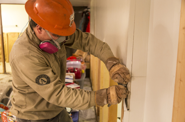 Inkster, MI, October 22, 2014 – AmeriCorps Disaster Response team member Kenny Kreslake, Arizona Conservation Corps, removes water-damaged drywall