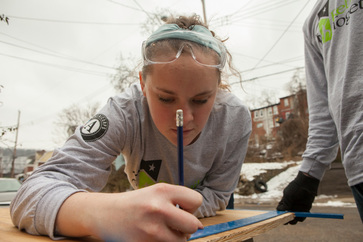 Martin Luther King, Jr. Day of Service 2014: An AmeriCorps member with Rebuilding Together builds a home for a family in need.