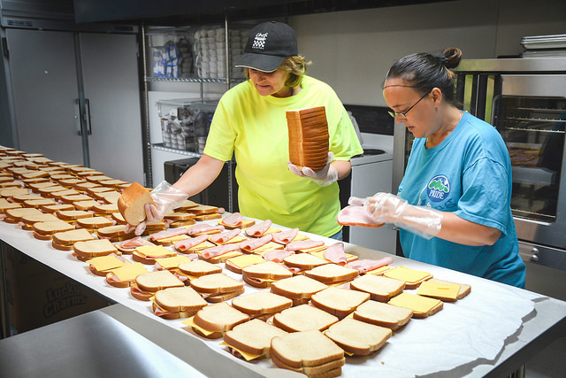 Kentucky Communities Economic Opportunity Council (KCEOC) staff, Latisha Smith (left) and Daphne Karr, prepare up to 1,800 sack lunches each day for c