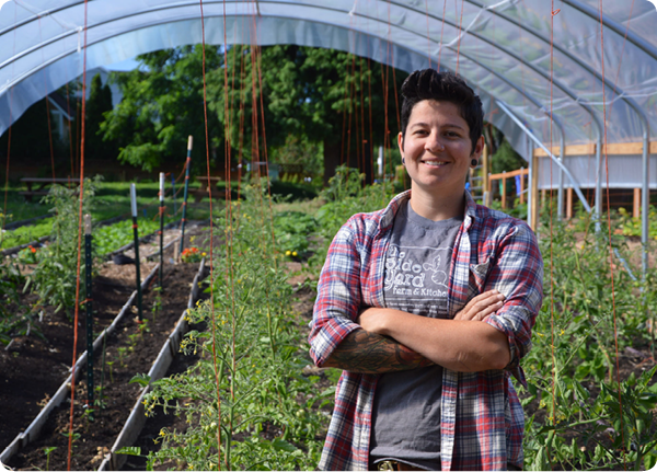 Stacey Givens of Side Yard Farm and Kitchen stands in a high tunnel built with assistance from the U.S. Department of Agriculture's (USDA) Natural Res