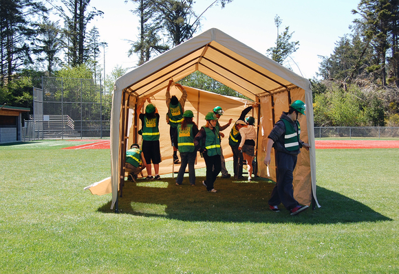 Taft High School Teen CERT students set up a tent that will be used to shelter students and staff after a large earthquake.