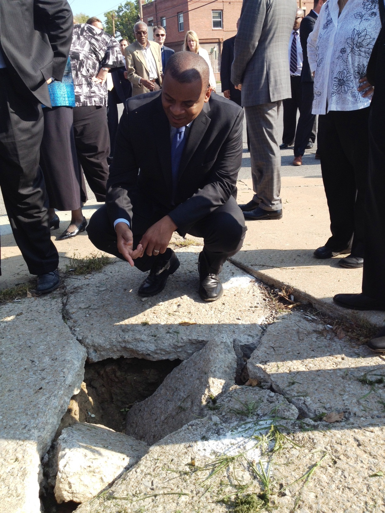 Photo of Secretary Foxx and gaping hole in KC sidewalk Photo of Secretary Foxx and gaping hole in KC sidewalk