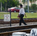 People trespassing illegally on rail tracks in West Palm Beach, Florida.