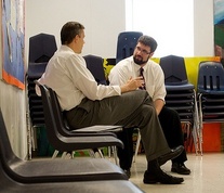 Arne Duncan talking with an educator in New Orleans