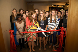 students cutting the ribbon on new exhibition