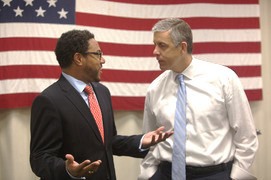 Arne Duncan speaks with an educator during a school visit.