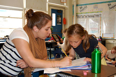 Teacher reading to student