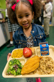 Girl with school lunch tray