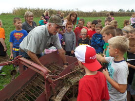 Farmer teaching children