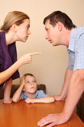 A boy watches as his parents fight.