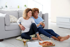 Couple watching TV at home