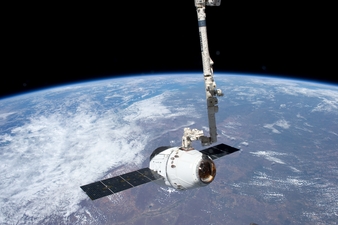 View from the International Space Station of the SpaceX Dragon spacecraft as the station�s robotic arm moves Dragon into place for attachment to the s