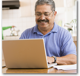 Hispanic man using laptop