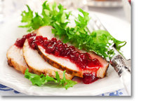 slices of turkey with cranberry sauce