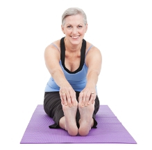 A woman stretching on a yoga mat.