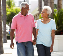Senior couple walking along the street together.