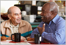 Two senior men having coffee.