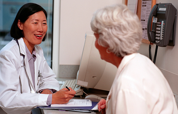 A senior woman consulting with a doctor.