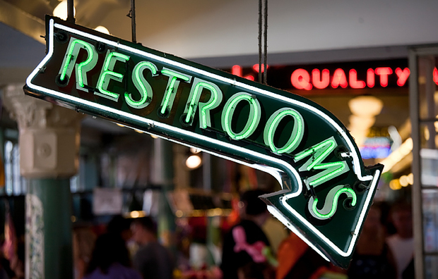 A neon sign that says "Restrooms".