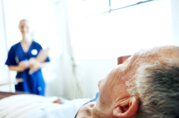 Elderly man in hospital bed